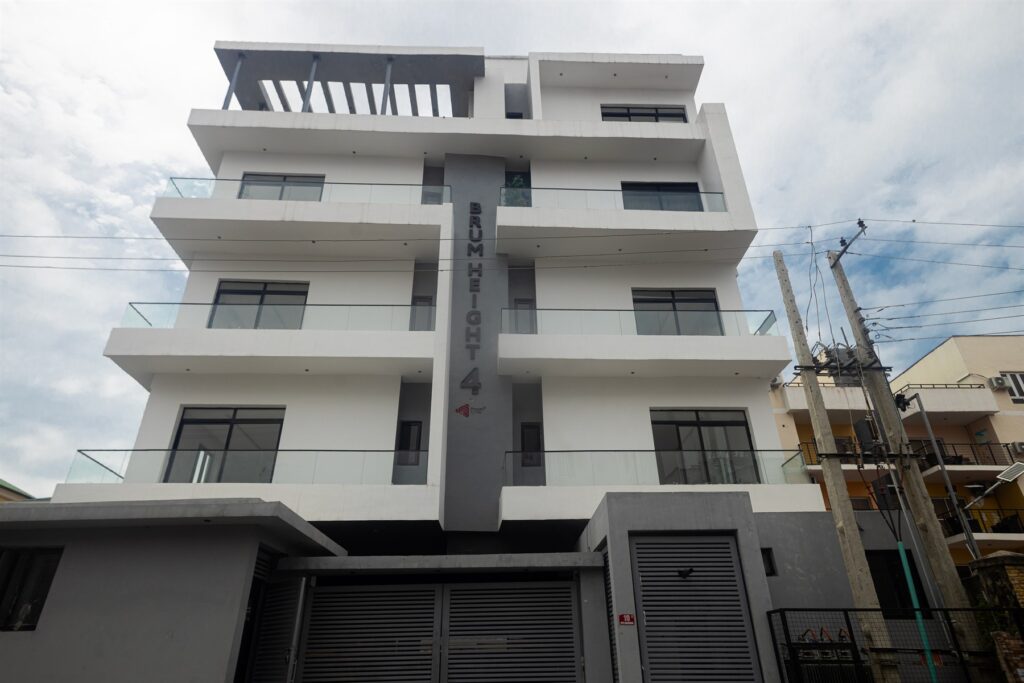 Brum Height 4: Front exterior with stacked balconies and a gated entrance